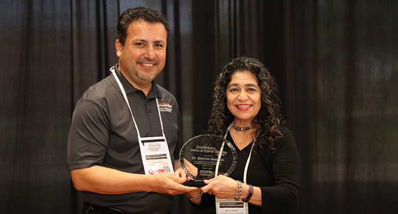 Director Francisco Garcia presenting the Excellence in Online/Hybrid Learning Award to Dr. Beatrice Newman